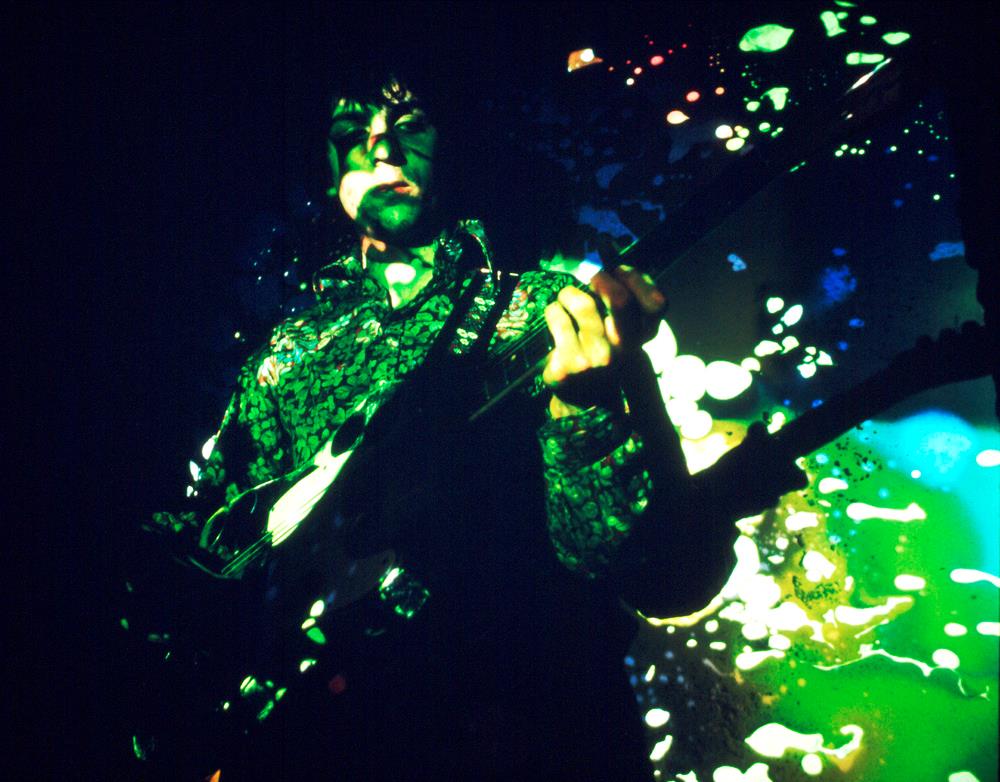 A Rockarchive limited edition print of Syd Barrett playing the guitar under green bubble lighting.