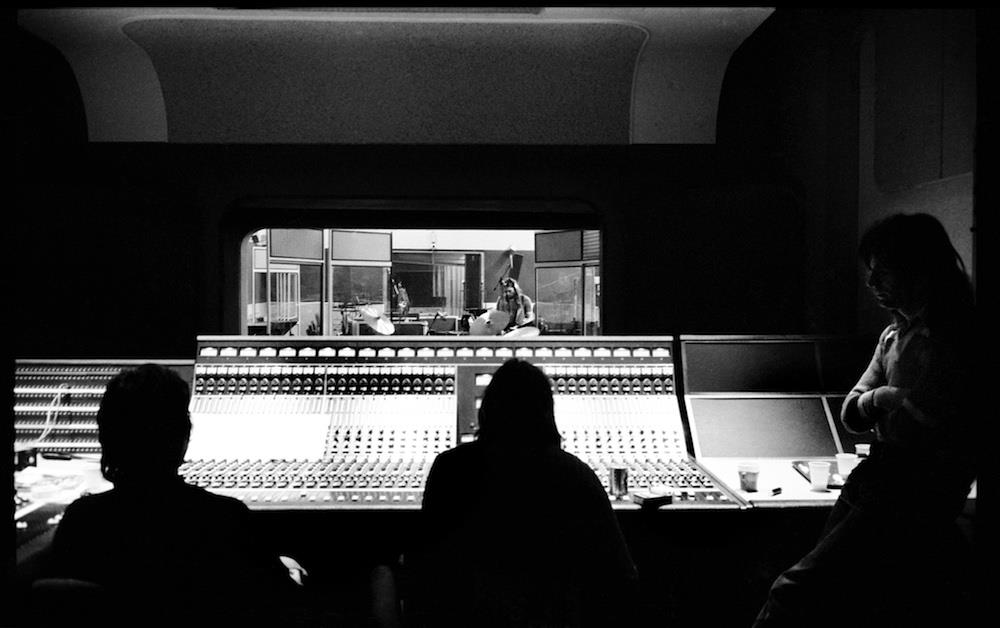 A Rockarchive limited edition print of Pink Floyd at the mixing desk recording Wish You Were Here with David Gilmour in the background.