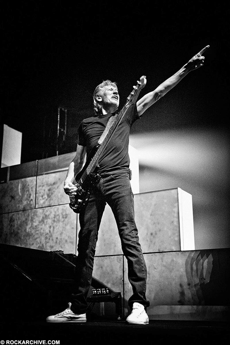 A limited edition print of Roger Waters, Pink Floyd stood with his arm pointing.