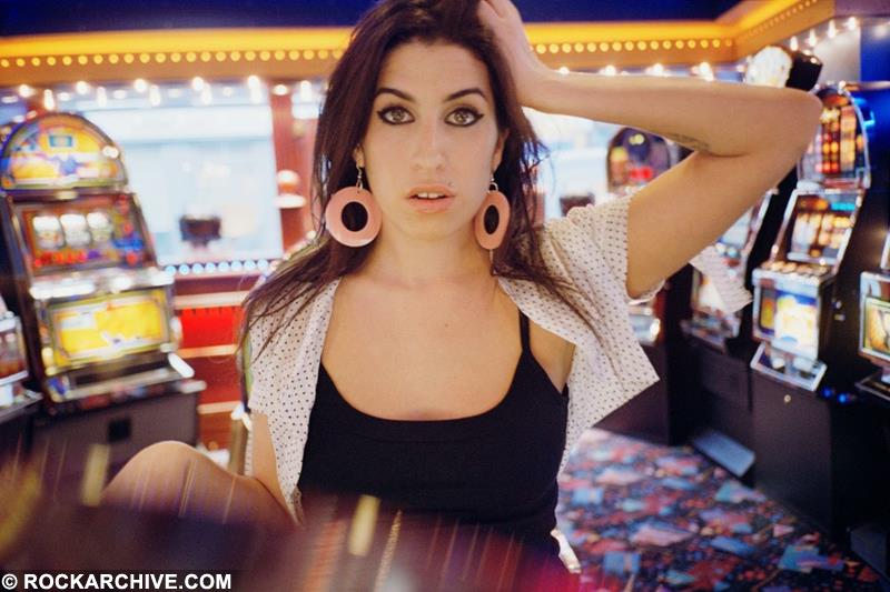 Amy Winehouse at an amusement arcade in Kentish Town in 2004 photographed by Jake Chessum