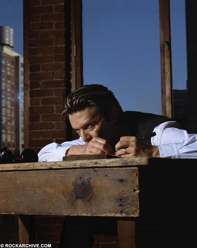 David Bowie photographed resting on a desk by Markus Klinko in 2001. This images is known ad Writer's Block