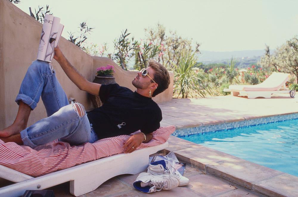 George Michael relaxing in St Tropez, France in 1988 photographed by Brian Aris