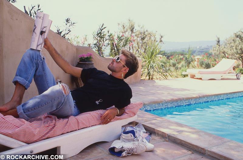 George Michael relaxing in St Tropez, France in 1988 photographed by Brian Aris