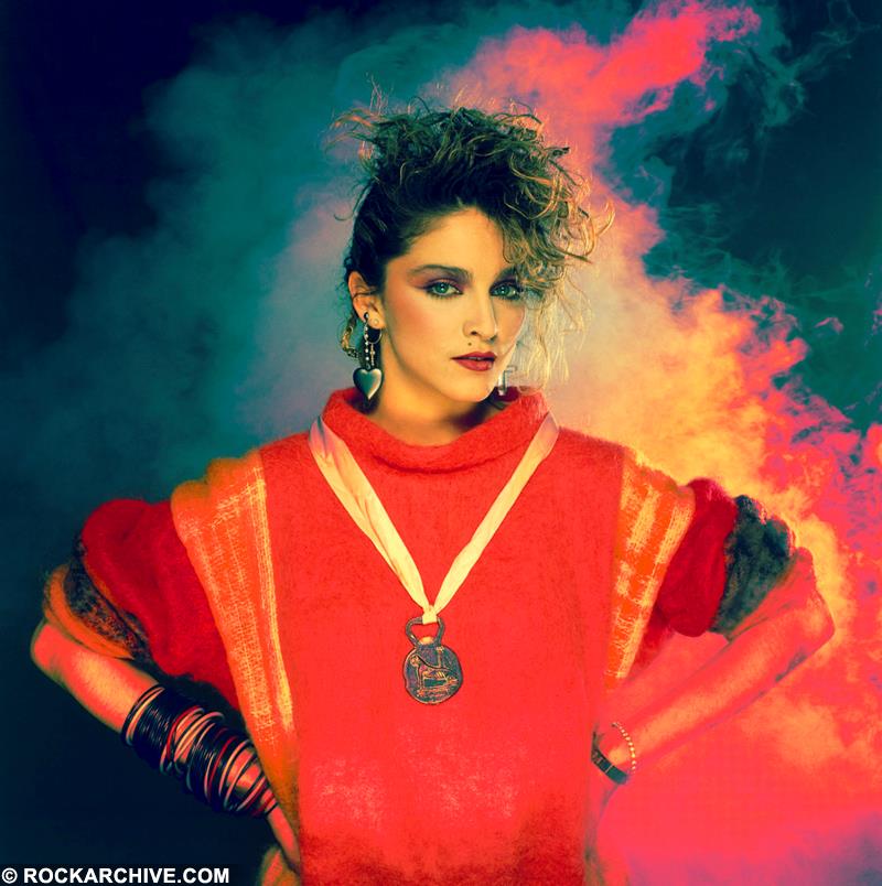 Madonna against a smokey red background in London in 1984 photographed by Brian Aris