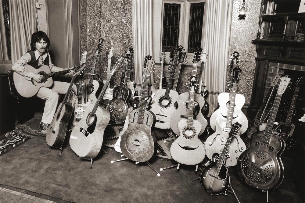 George Harrison at home with his guitar collection in 1979 photographed by Brian Aris