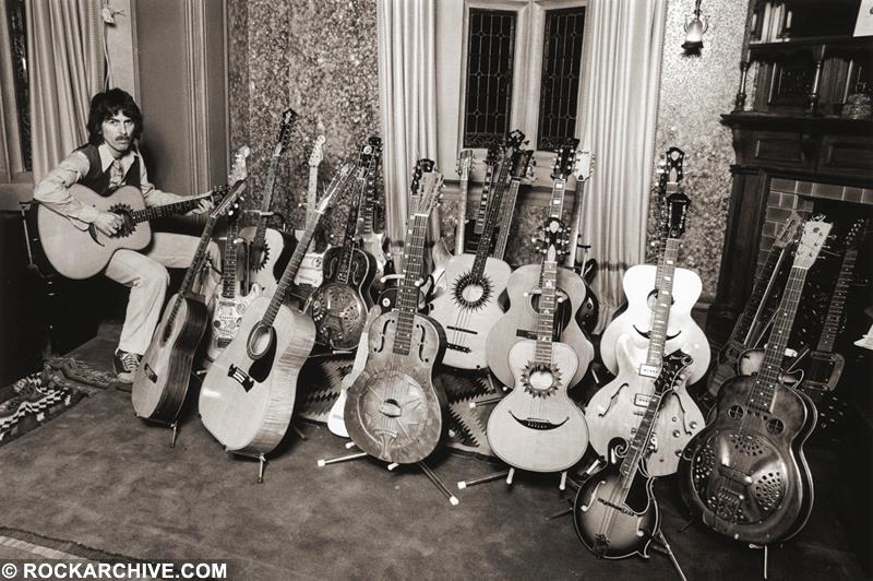 George Harrison at home with his guitar collection in 1979 photographed by Brian Aris