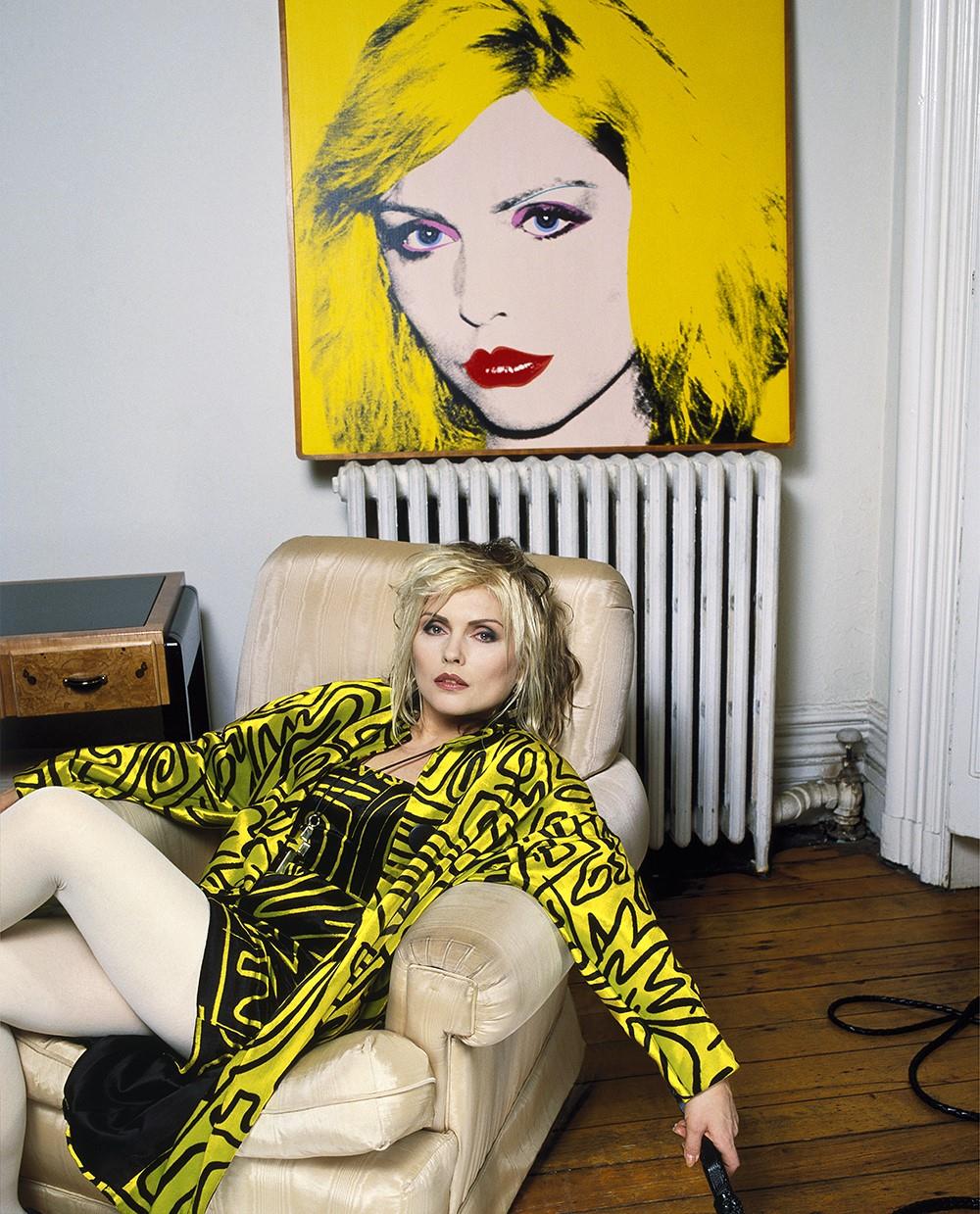 Debbie Harry reclining on a chair in her New York apartment in 1988