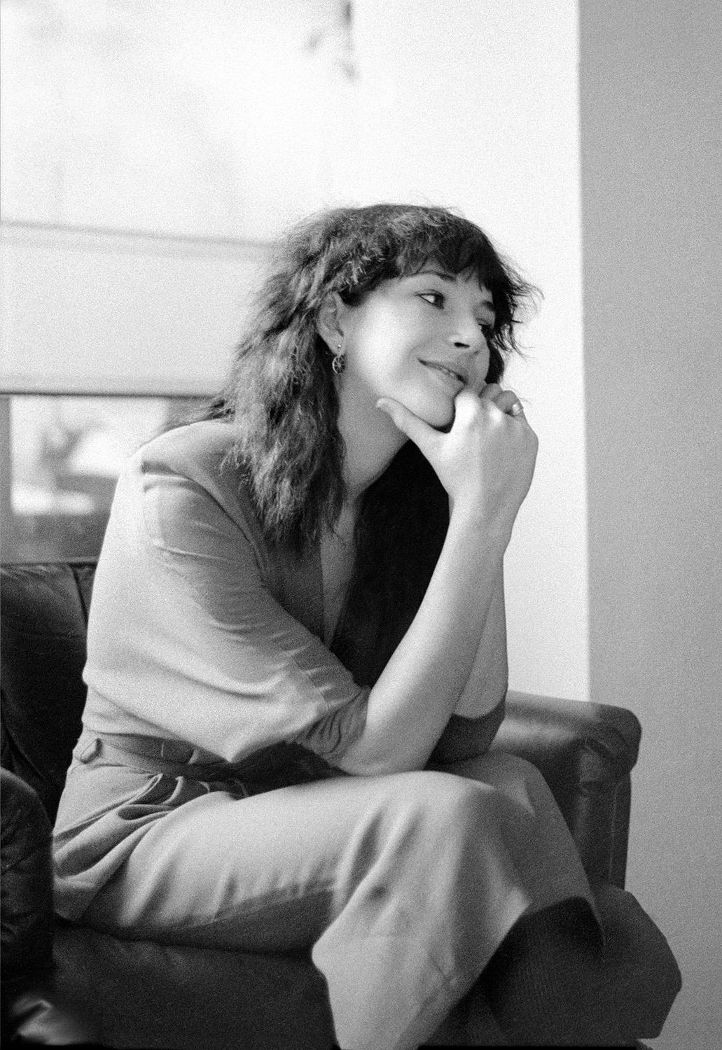 A relaxed looking Kate Bush sitting on a chair in September 1979