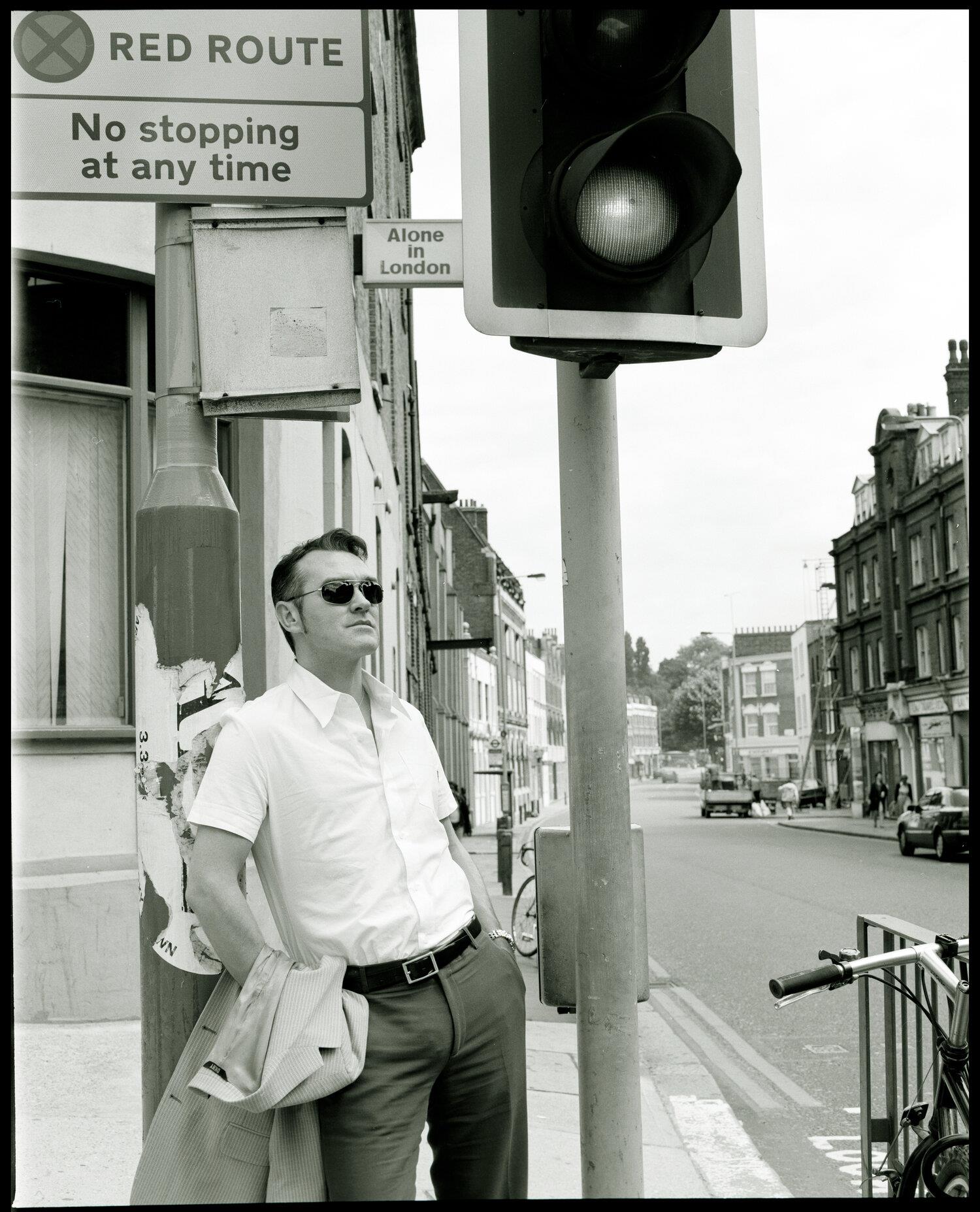 A limited edition print of Morrissey stood alongside a London traffic light.
