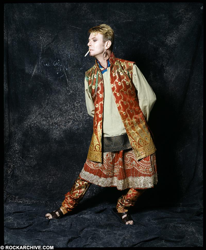 A limited edition colour print of David Bowie wearing an Indian dress and trousers.