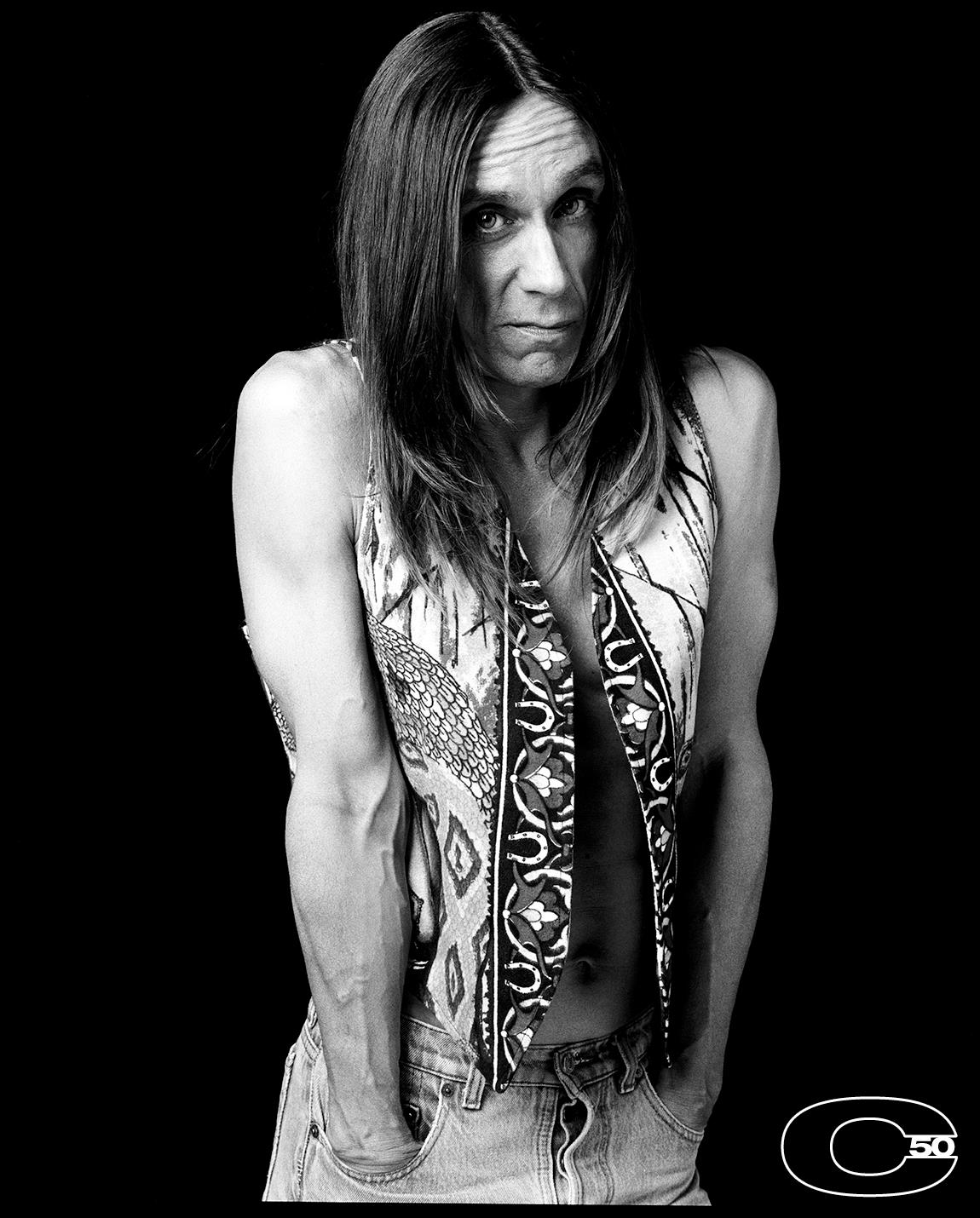 A limited edition print of Iggy Pop wearing a patterned waistcoat with bare arms in 1993.