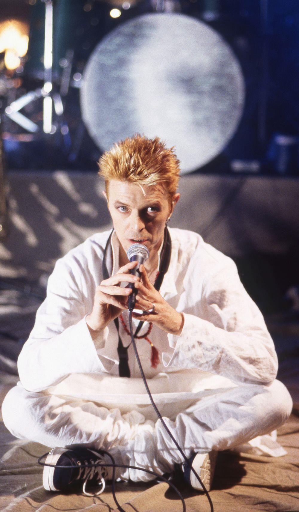 A limited edition print of David Bowie sat cross-legged whilst rehearsing in London in 1997.