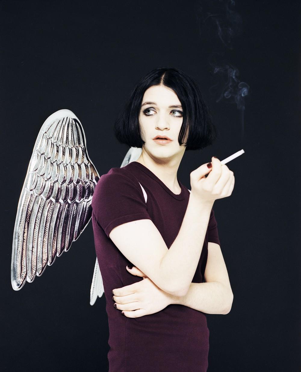 A limited edition print of Brian Molko from Placebo wearing a pair of angel wings.
