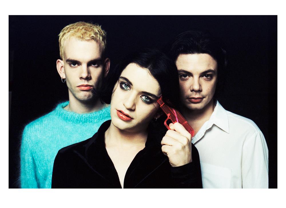 A limited edition colour print of Placebo stood against a black background.
