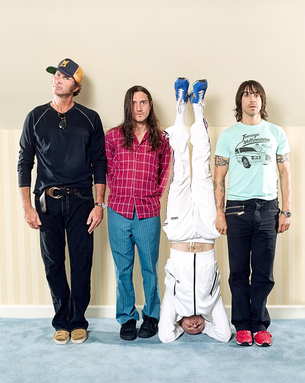 A limited edition colour print of the Red Hot Chilli Peppers against a wall.