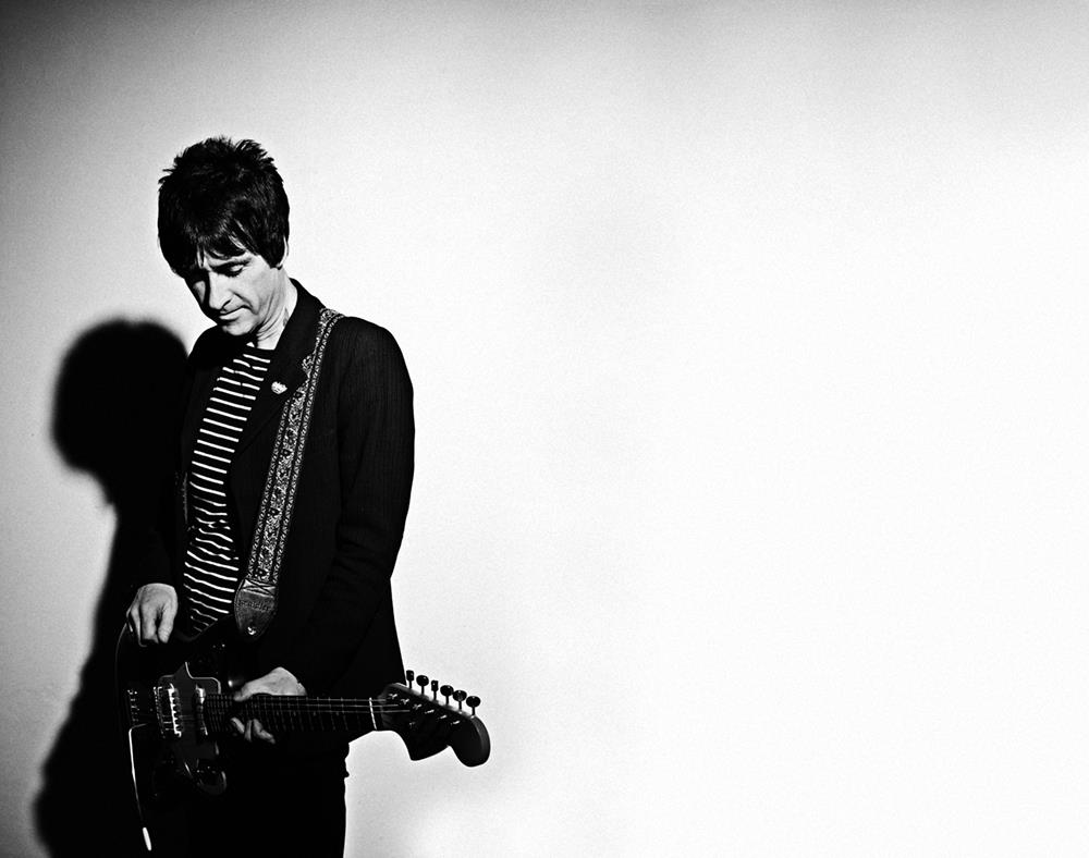 A limited edition print of Johnny Marr holding a guitar.