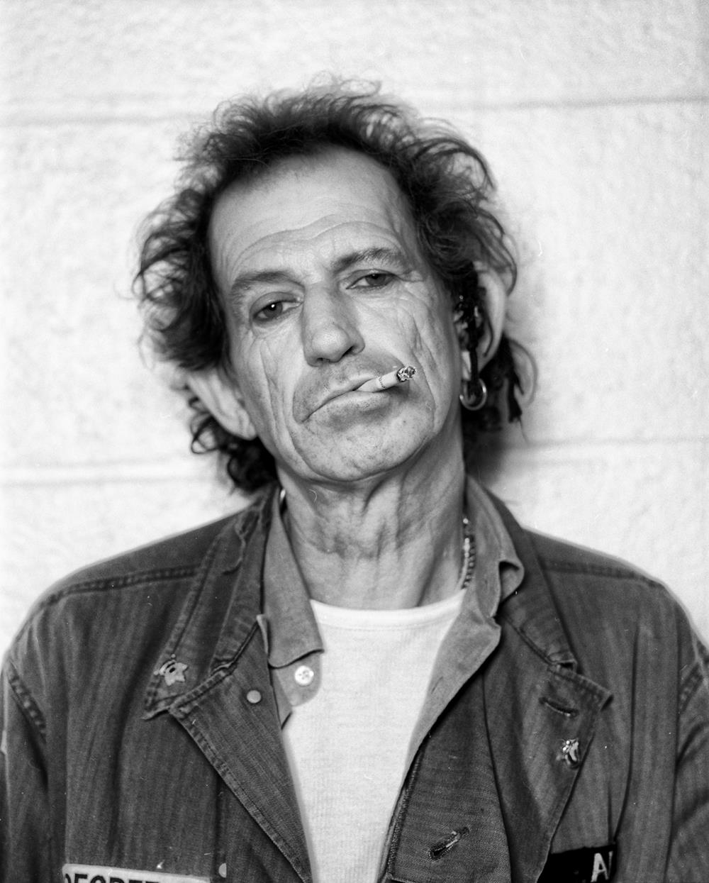 A limited edition print of Keith Richards smoking a cigarette and looking at the camera.