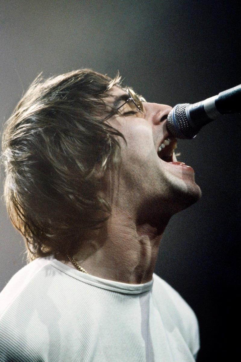A limited edition colour print of Liam Gallagher, Oasis singing into a microphone .