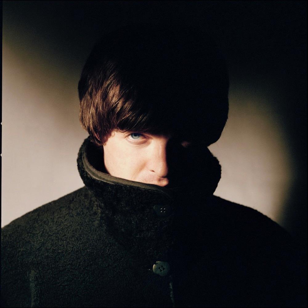 A limited edition colour Rockarchive print of Noel Gallagher, Oasis with face in shadow.