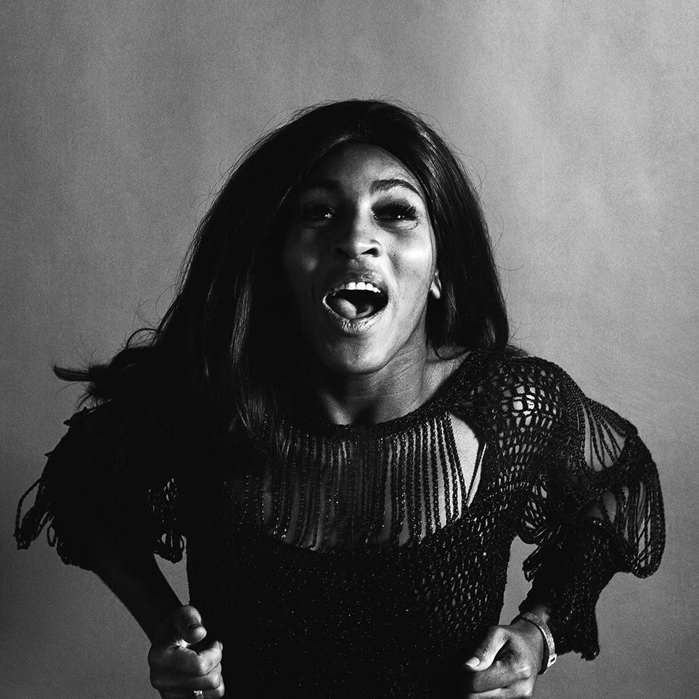 A limited edition print of Tina Turner leaning forward and starring into the camera.