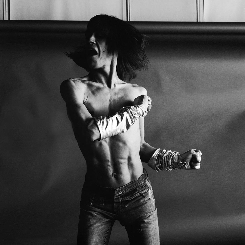 A limited edition print of a bare torsoed Iggy Pop twisting from side to side.