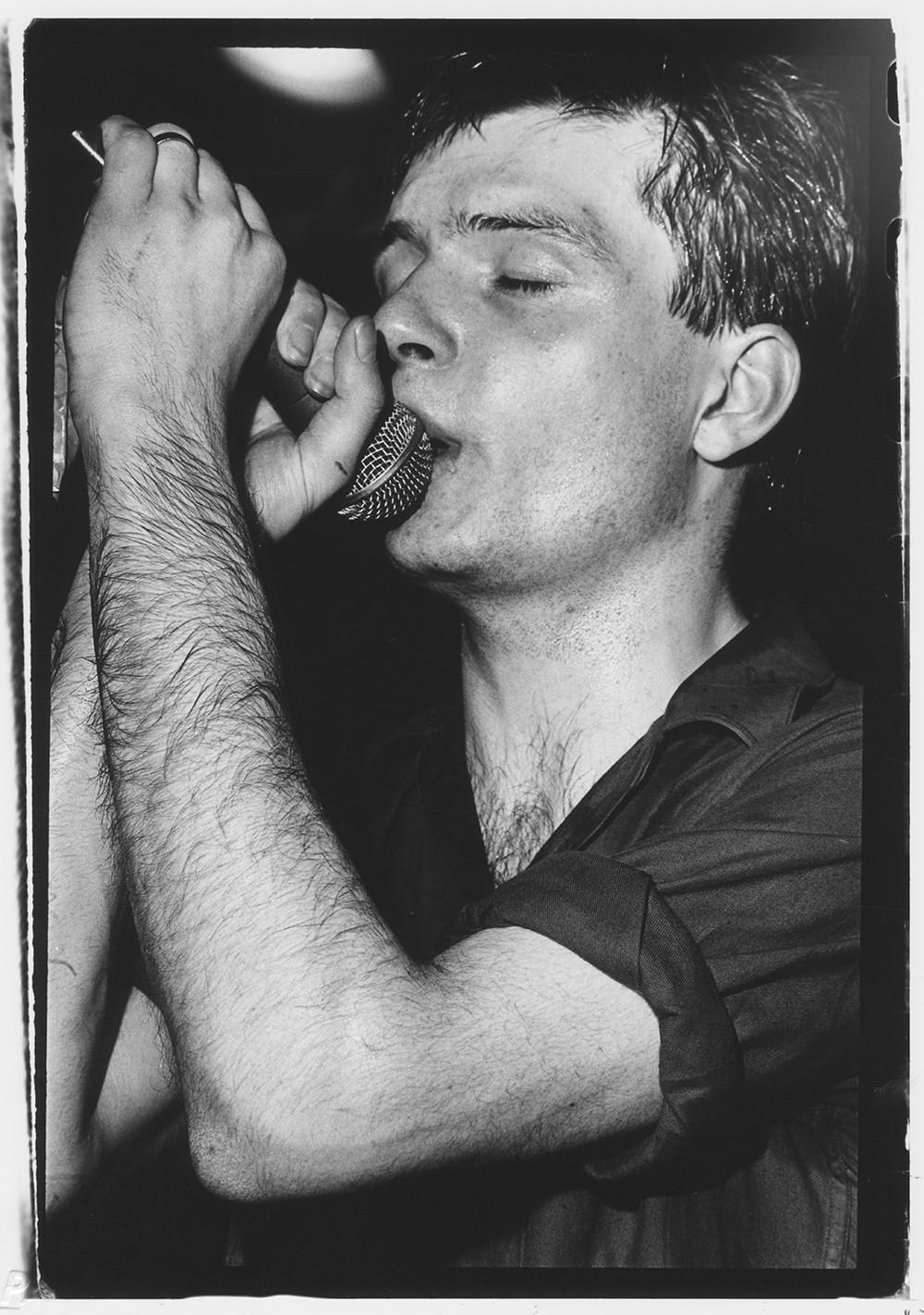 A limited edition print of Joy Division's Ian Curtis holding a microphone.