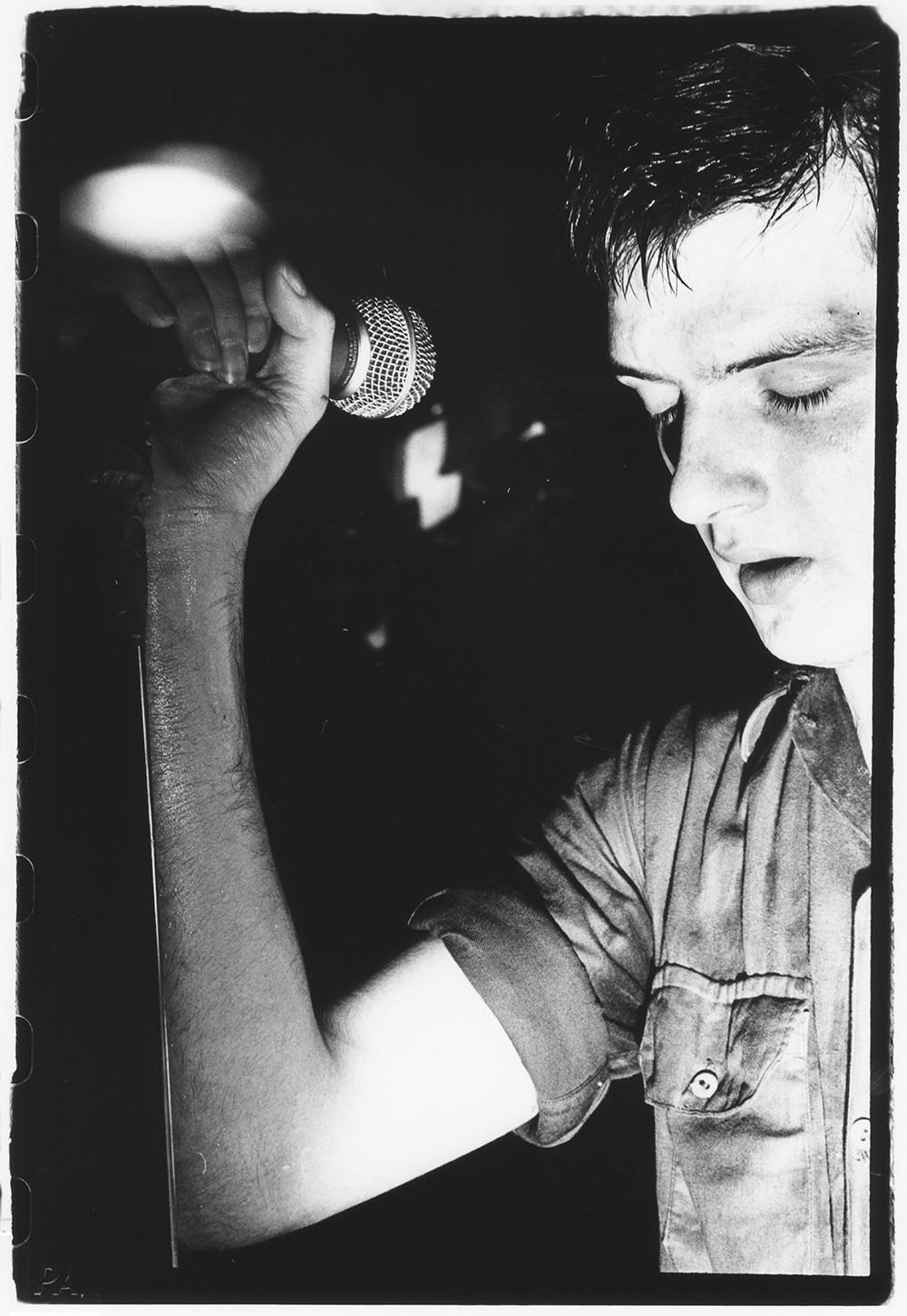 A limited edition print of Ian Curtis, lead singer of Joy Division, stood with his eyes closed