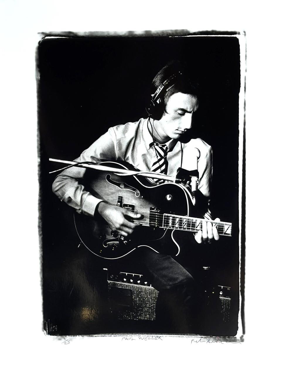 A limited edition print of Paul Weller playing guitar in the recording studio.