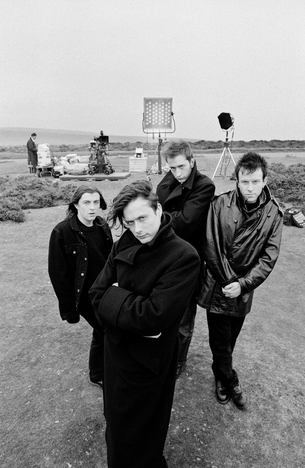  A limited edition print of Britpop group Suede stood outside with filming equipment.