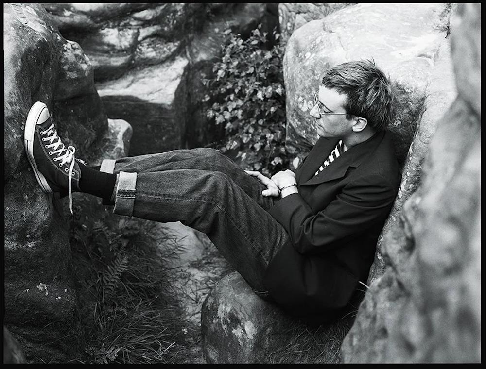 A limited edition print of Blur's lead guitarist, Graham Coxon, sat amongst rocks.