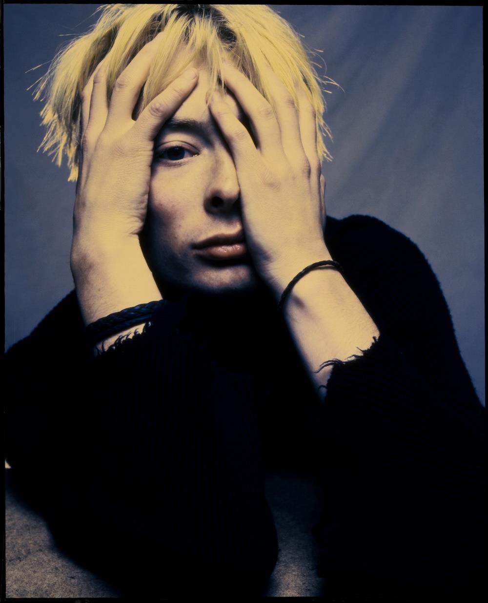 A limited edition colour print of Thom Yorke, Radiohead with his hands on his head.