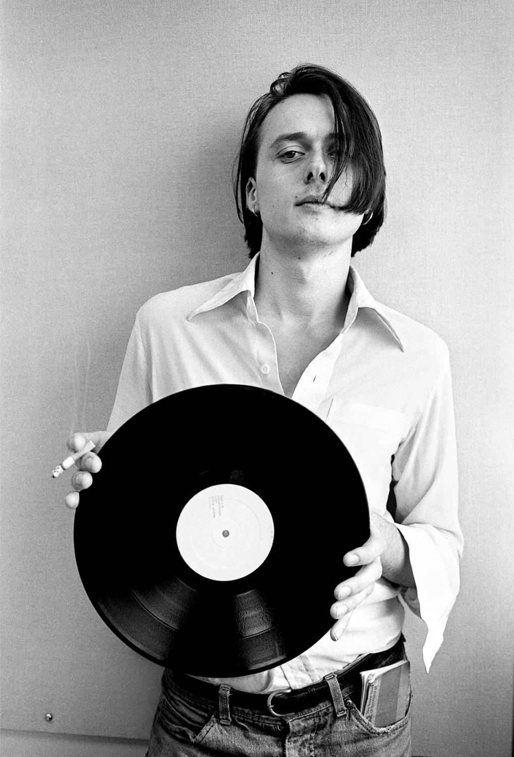 A limited edition Rockarchive print of Suede's Brett Anderson holding a vinyl 12" record.
