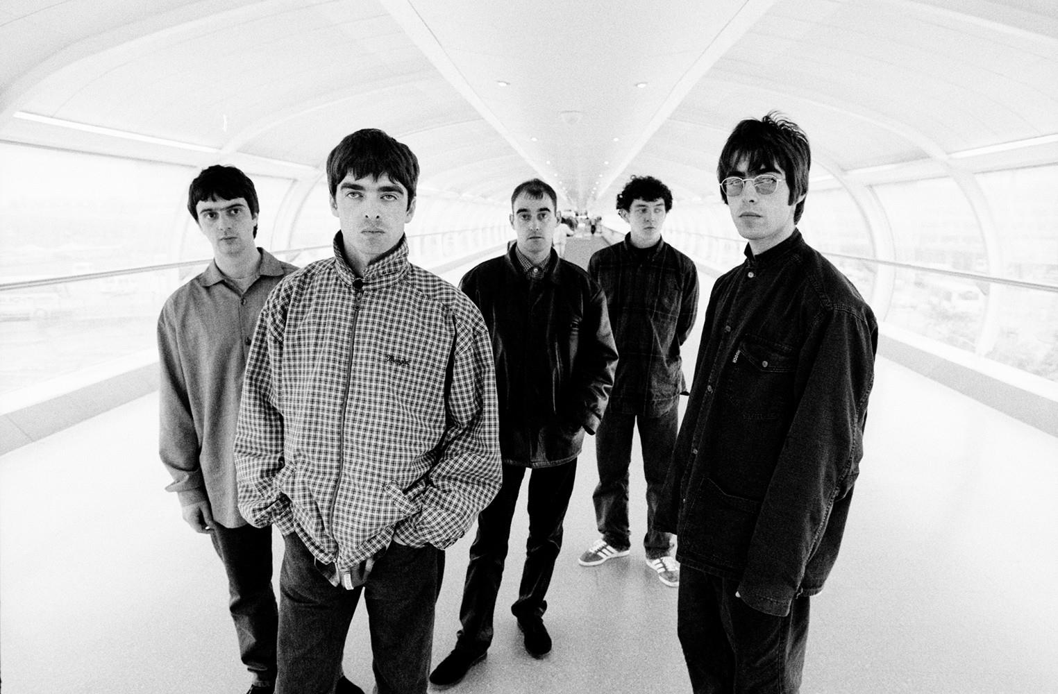 A fine art print of a group shot of Oasis taken at Manchester Airport in 1994.