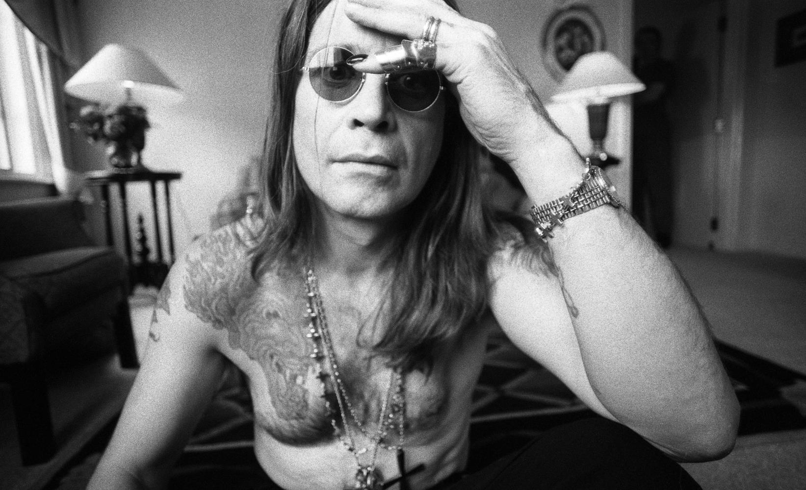 A limited edition print of a bare chested Ozzy Osbourne holding his hand to his head