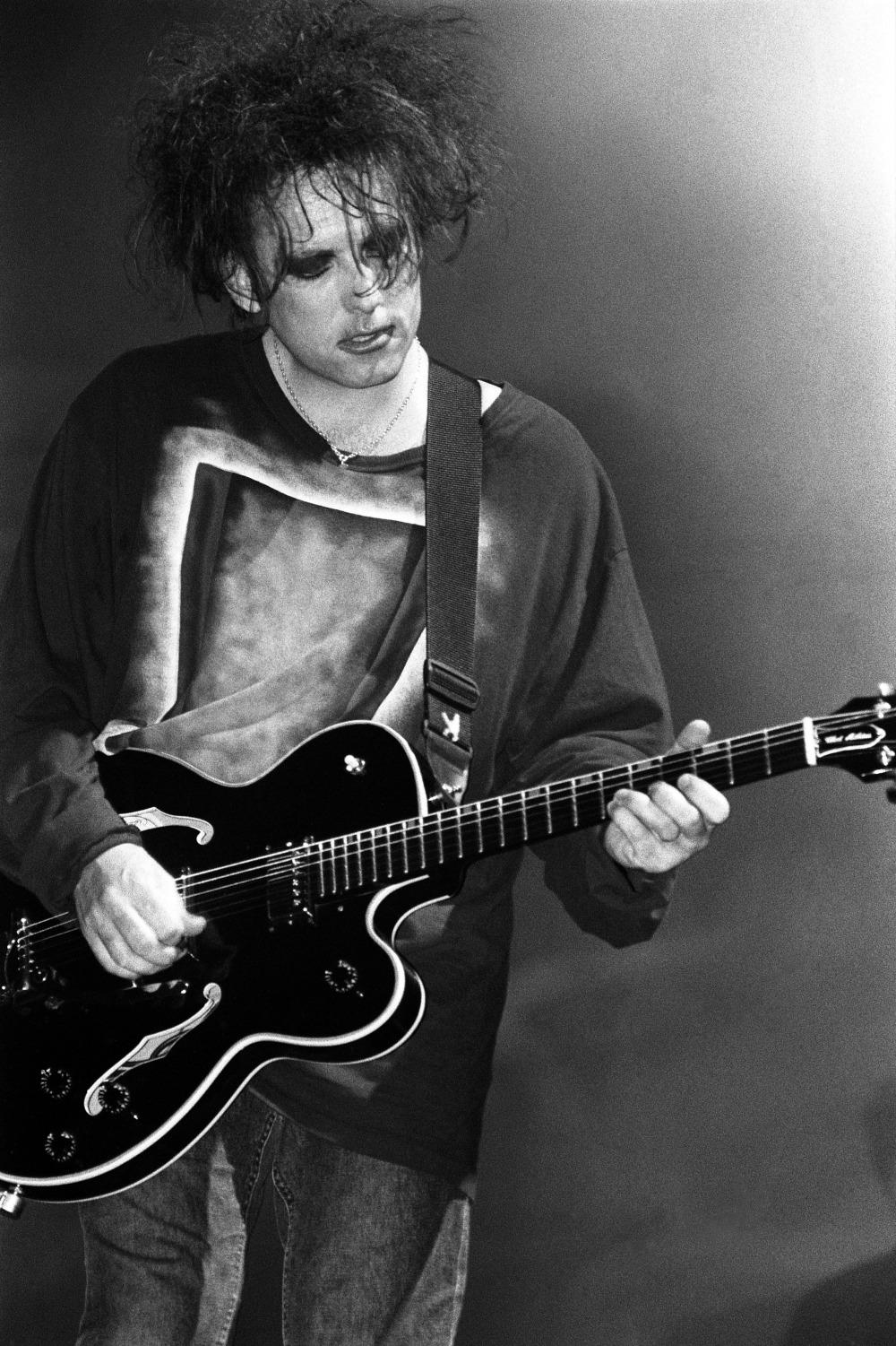 A limited edition print of Robert Smith, The Cure playing guitar at the Glastonbury Festival in 1995.