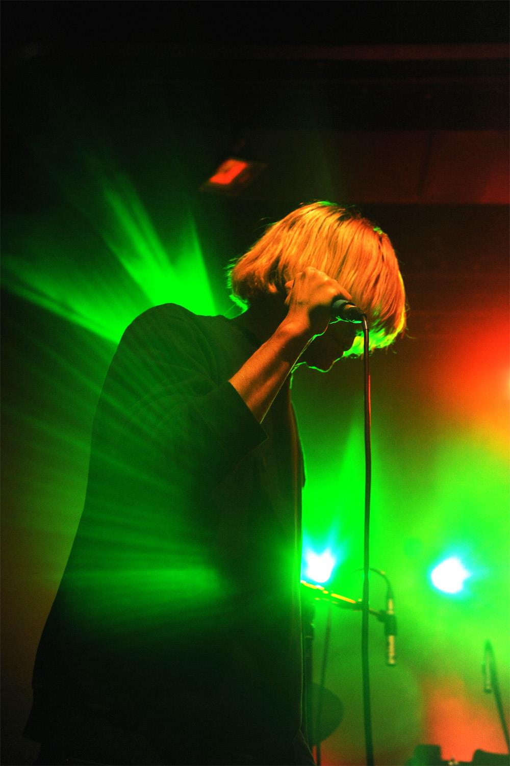 A limited edition colour print of Tim Burgess from The Charlatans holding a microphone.