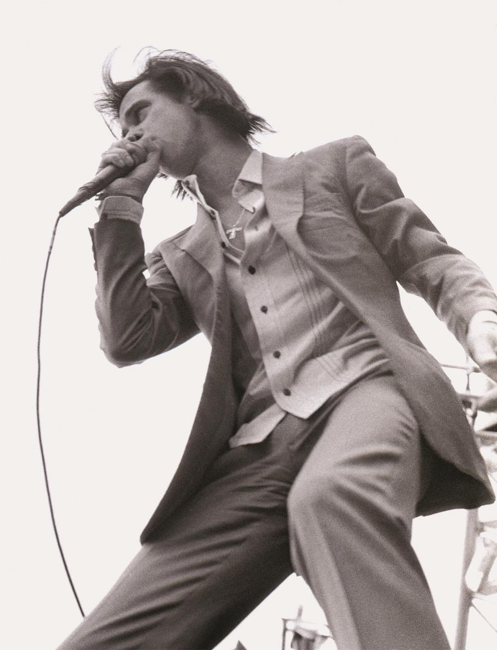 A limited edition print of Nick Cave holding a microphone singing.