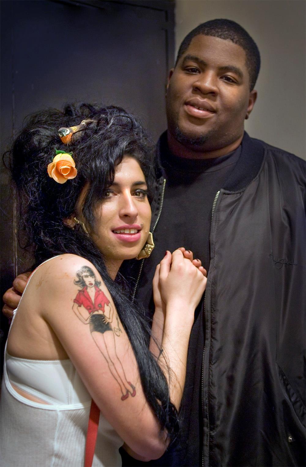 A limited edition colour print of Amy Winehouse posing with Remi Salaam looking at the camera.