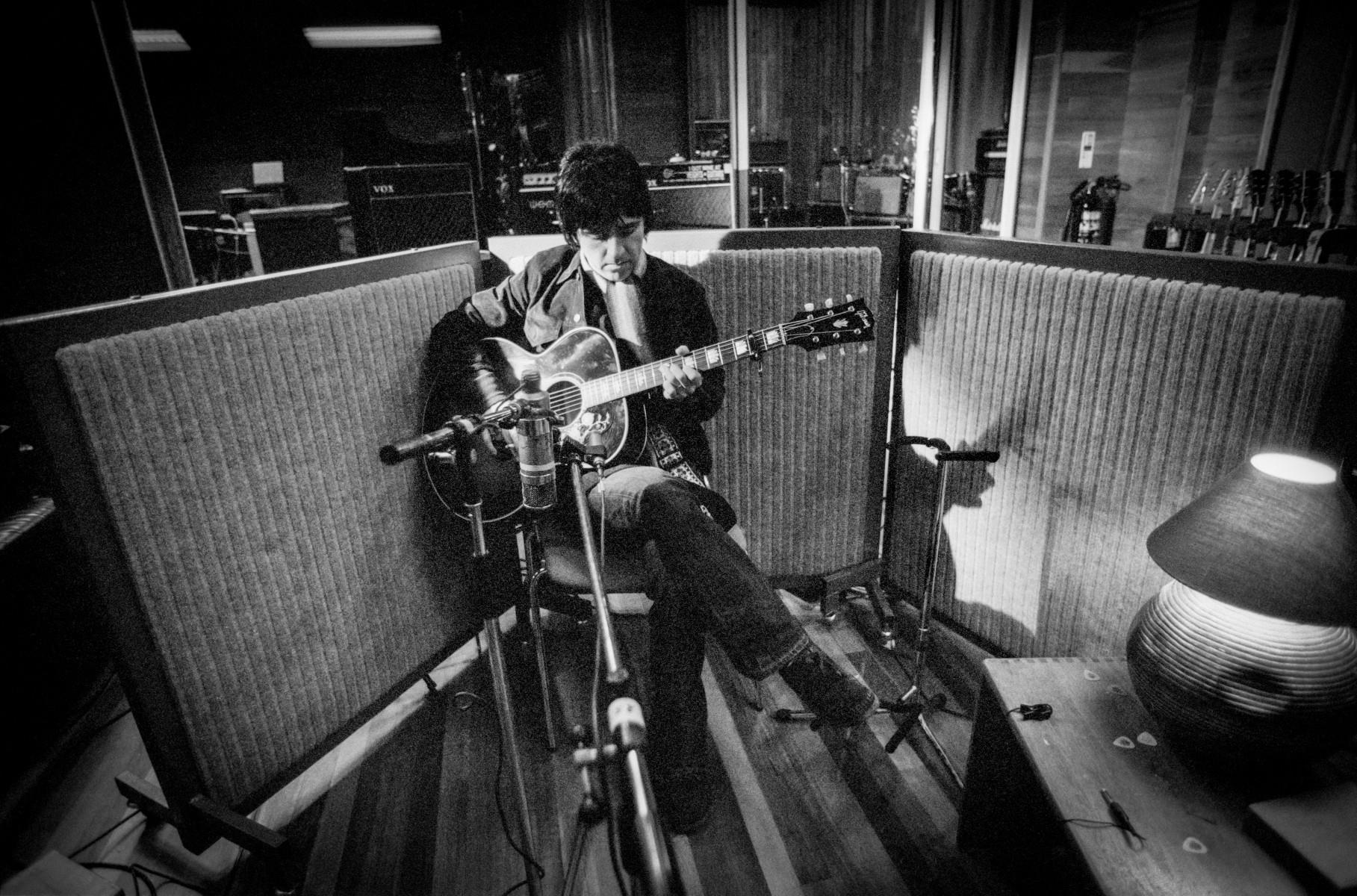 A limited edition print of Johnny Marr sitting with a guitar by a mic in Olympic Studios in 2001.
