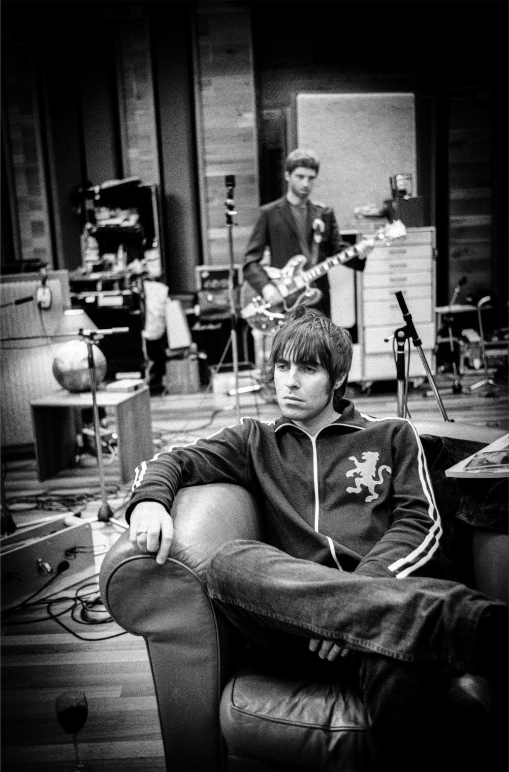 A limited edition print of Liam and Noel Gallagher with Liam sitting and Noel playing guitar behind in Olympic Studios, 2001.