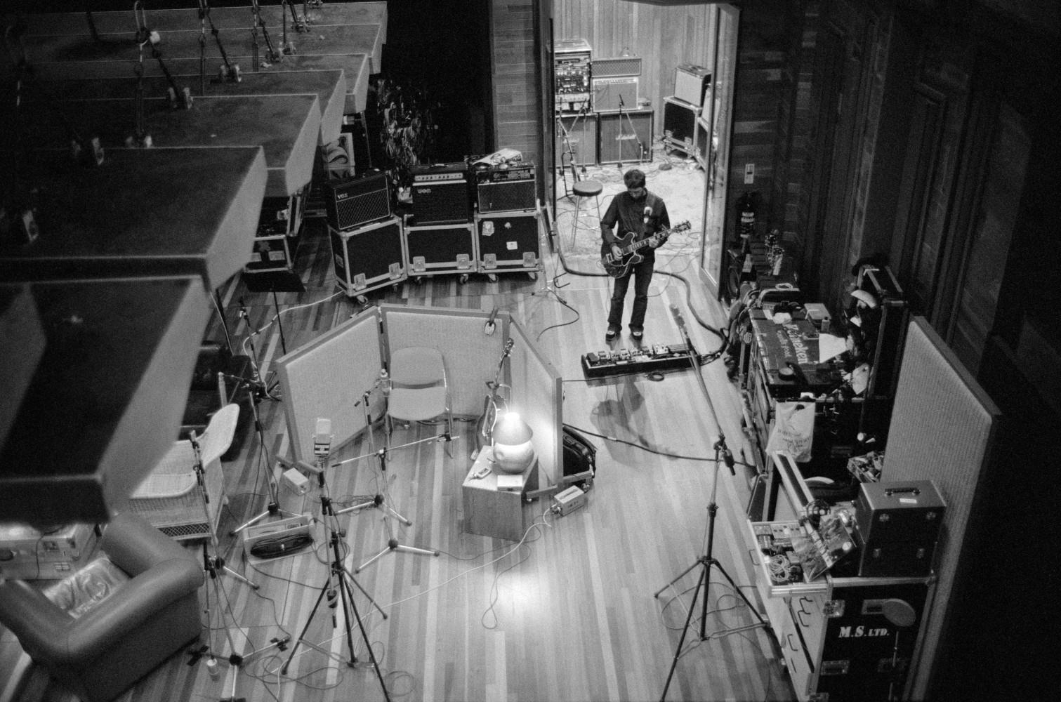 A limited edition print looking down at Noel Gallagher with a guitar in the Olympic Studios in 2001.